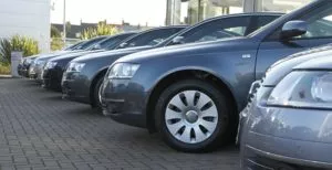 Multiple gray cars in a parking lot