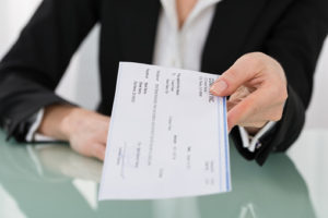 Person holding a paycheck