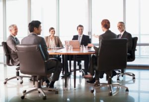 People sitting around a table in a meeting