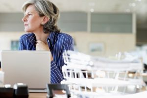 Woman sitting at a desk with a laptop