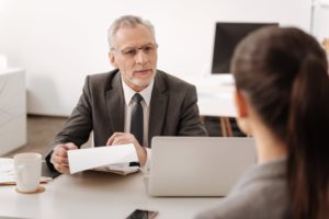 Man talking to a women at a desk