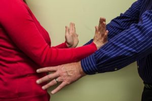 Person touching another person while they motion to stop