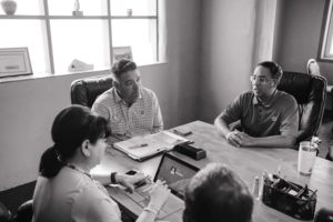 Black and white image of people in a meeting