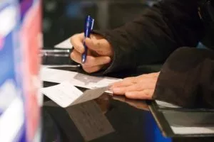 Person writing a check