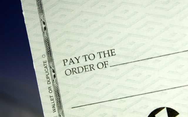 Close up of a check with the words "pay to the order of"