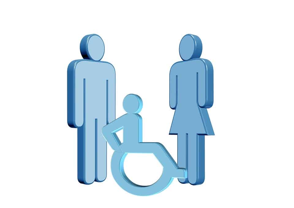 man standing, person in wheelchair, and woman standing