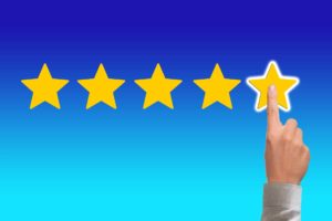 Five start rating with a persons hand point at the fifth star