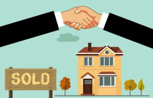 Illustration of two hands shaking over a house with a "sold" sign