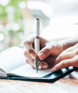 Picture of person writing in journal.