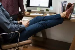 Person sitting with their feet up on a desk