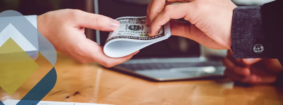 Person handing over cash in business setting